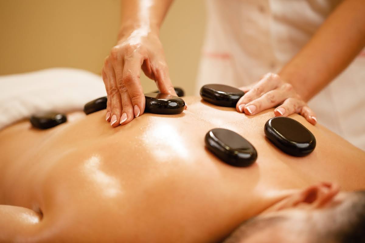 Man undergoing a hot stone massage. 
